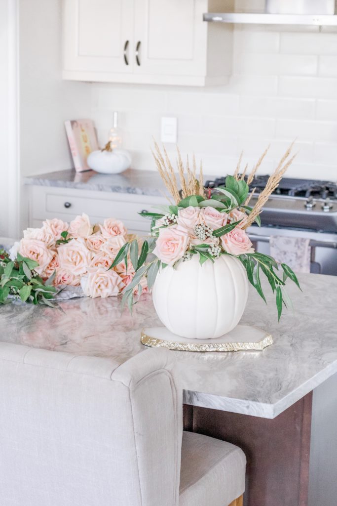 Pink roses on kitchen counter with pumpkin vase
