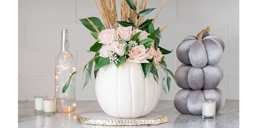 DIY Pumpkin vase with pink roses and greenery