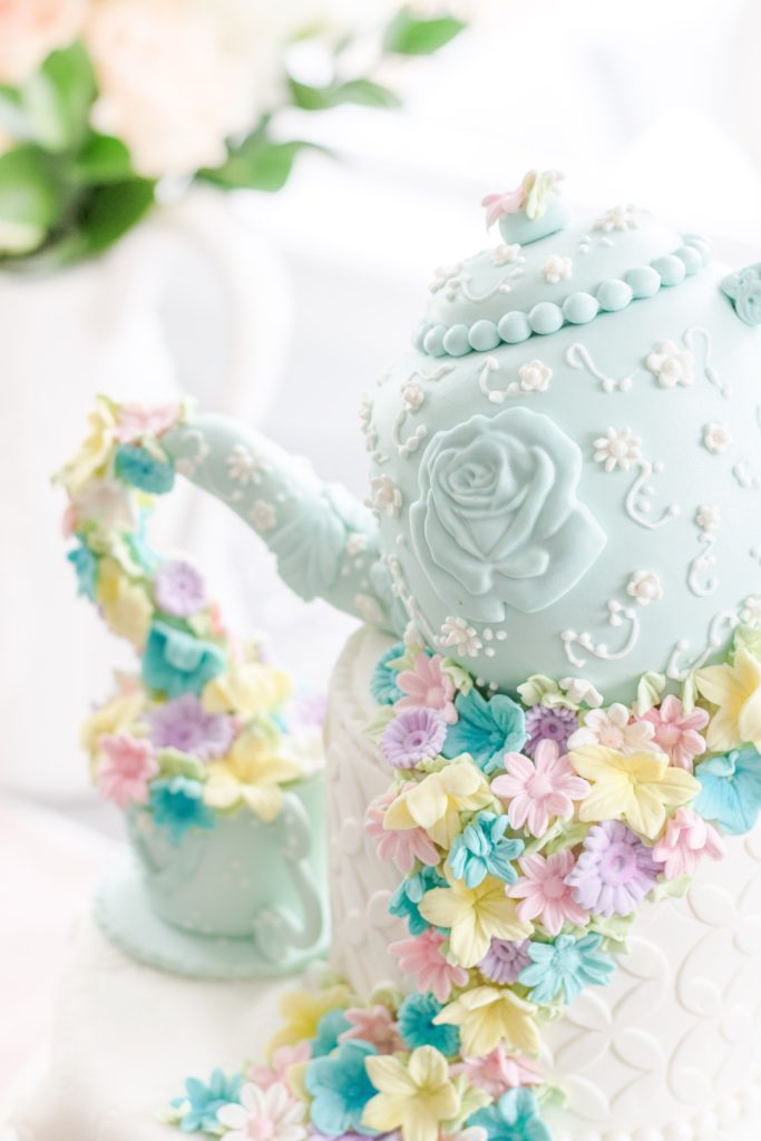Closeup of mint blue tea pot birthday cake
