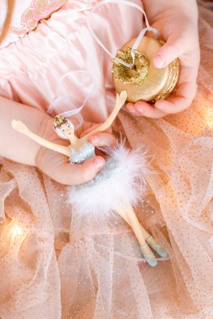 Ballerina Christmas ornament held by girl in pink tutu