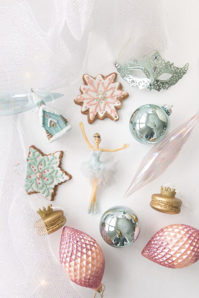 Variety of white, silver, pastel pink and pastel blue Christmas ornaments