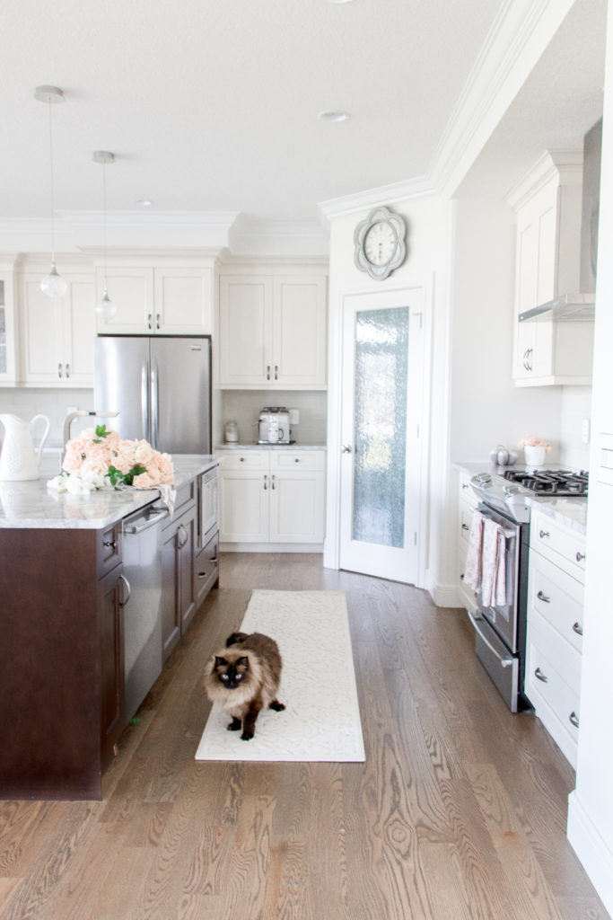 White and brown kitchen with rug runner