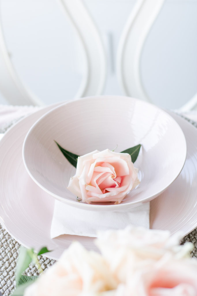 Closeup shot of pink rose in pink dinnerware