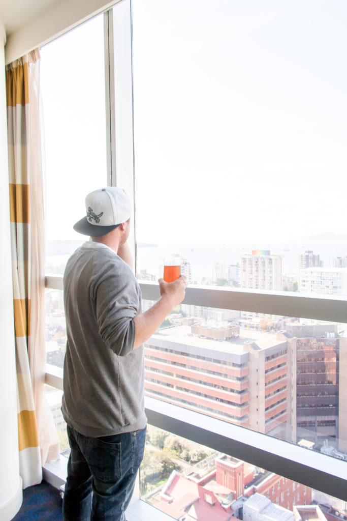 Aaron Hunka taking in Sheraton Vancouver Wall Centre room view