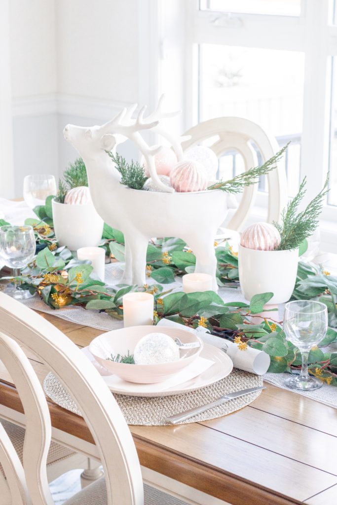 Christmas tablescape with white deer centrepiece and fresh greenery