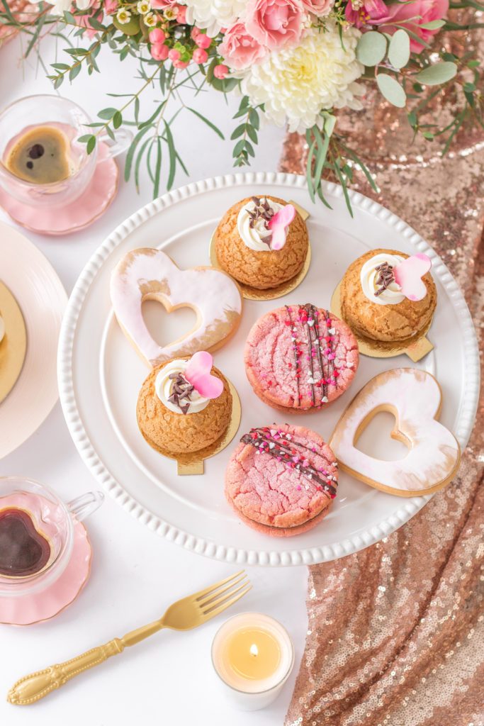 Overhead shot of Valentine's Day Dessert ideas including cream puffs and sugar cookies