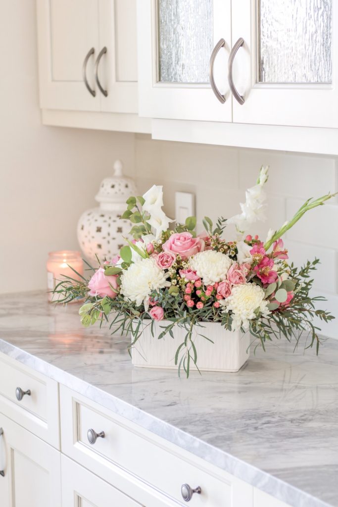 Pretty pink Valentines Day flower arrangement in white kitchen