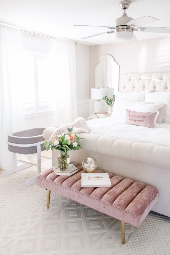 Light and bright bedroom with Monte baby bassinet and pink velvet bench