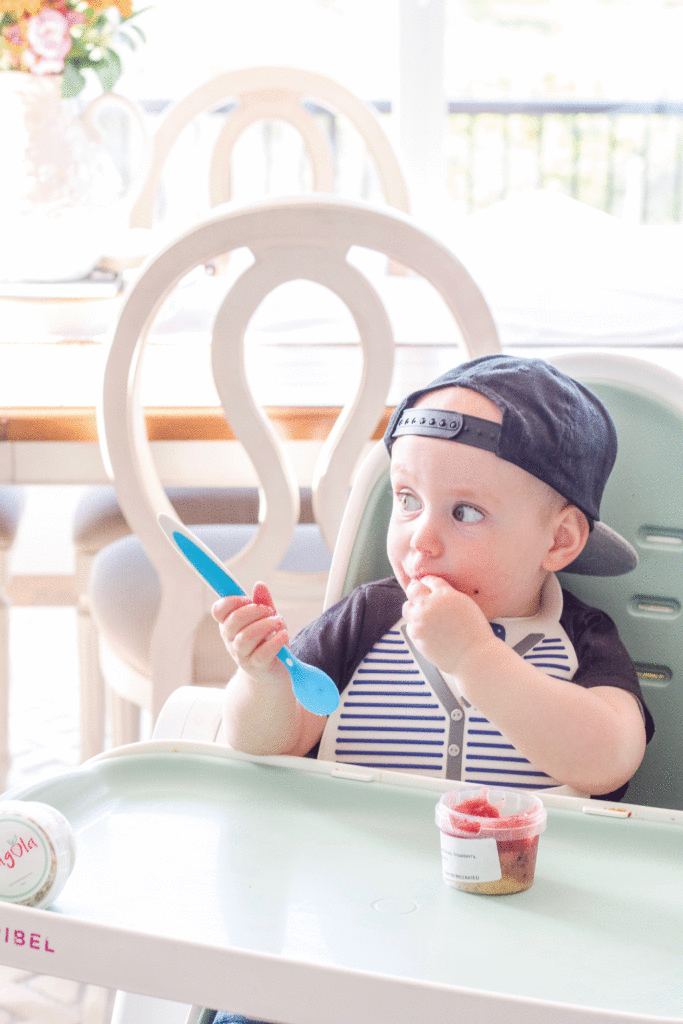 Baby boy eating Fragola baby food in Oribel high chair