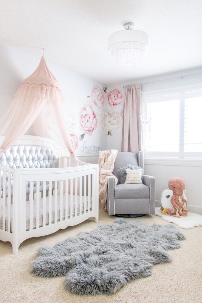 Pink peony nursery : cute pink girls nursery with peony wall decals, pink tulle crib canopy, silver tufted crib and gray recliner