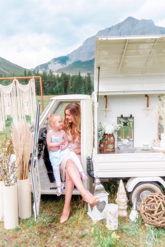 Mother and daughter cozied up in Bubbles and Brews Prosecco cart and champagne truck