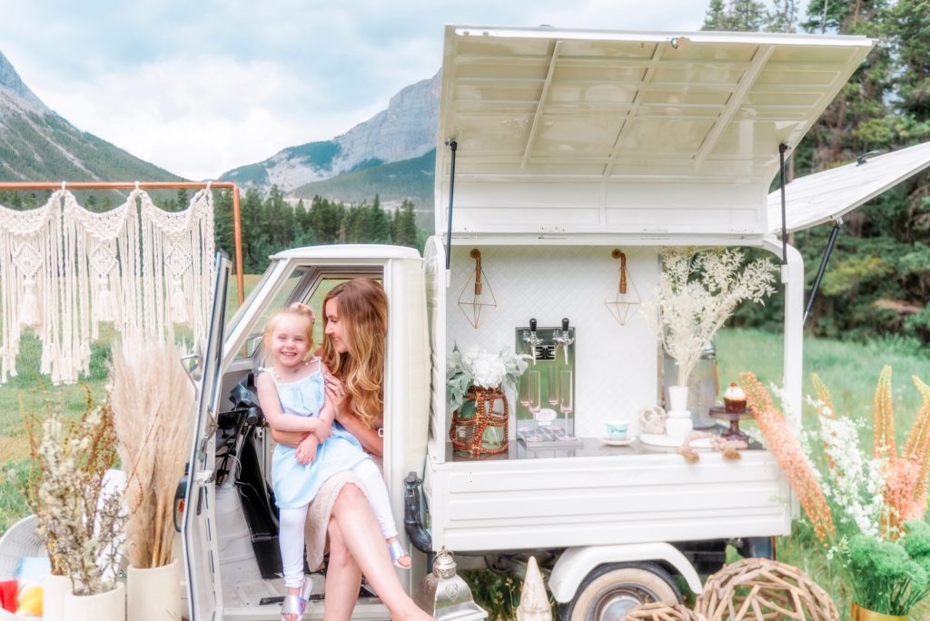 Mom and daughter enjoying a mobile Prosecco cart in the Canadian Rocky Mountains