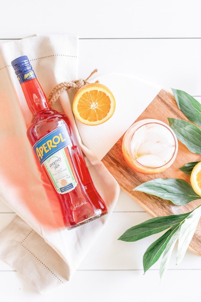 Flatlay of ingredients needed to make a classic Aperol Spritz cocktail 