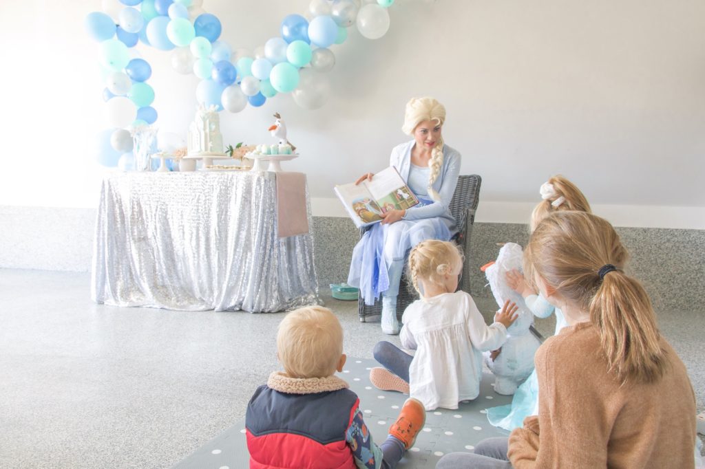 Ice Queen with Glass Slipper Entertainment in Edmonton reading Frozen birthday party guests a book