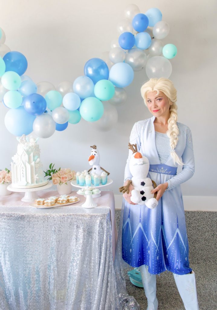 Queen Elsa of Arendelle at a Frozen birthday party with Olaf