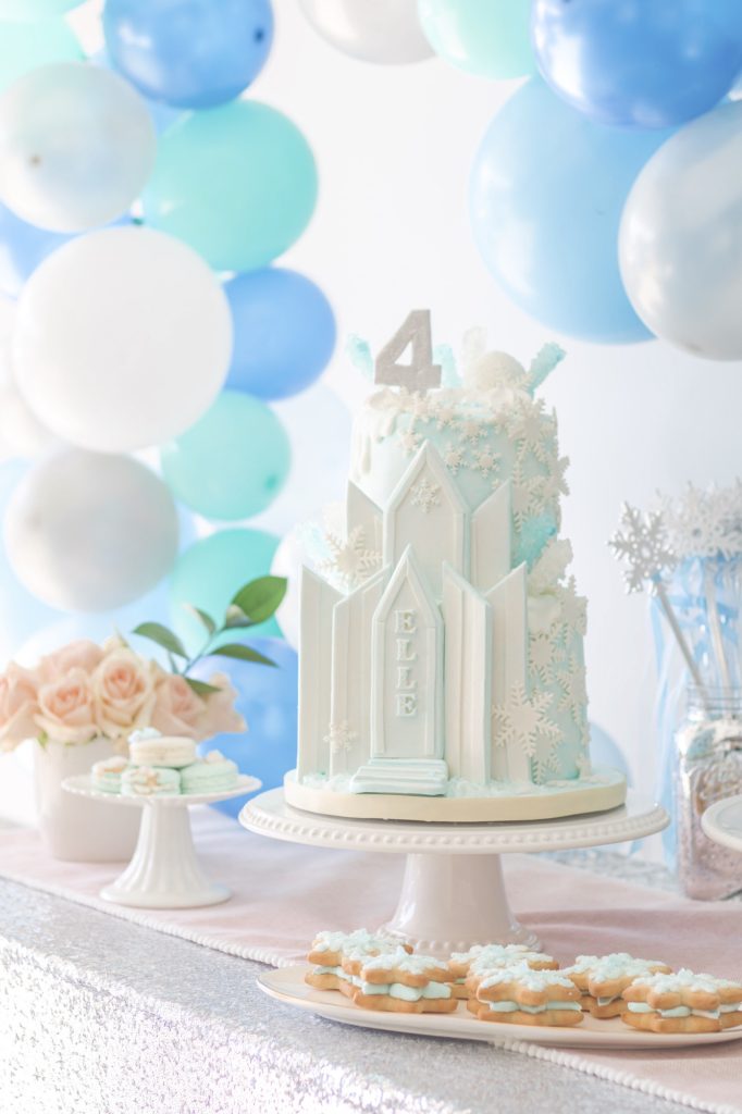 Ice Castle Frozen Birthday Party cake with snowflake cookies