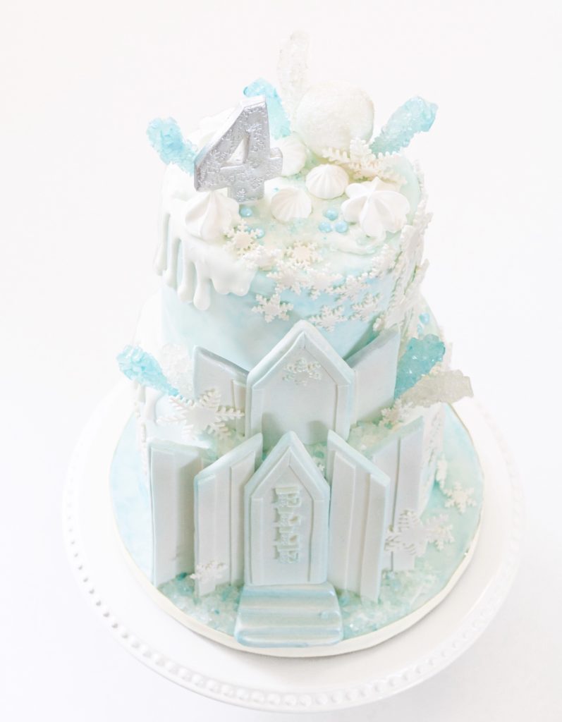 Beautiful pastel blue Frozen Ice Castle birthday cake for Elsa lovers
