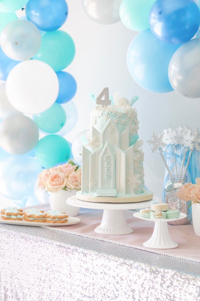 Stunning pastel blue Frozen birthday cake with glamorous birthday party decor