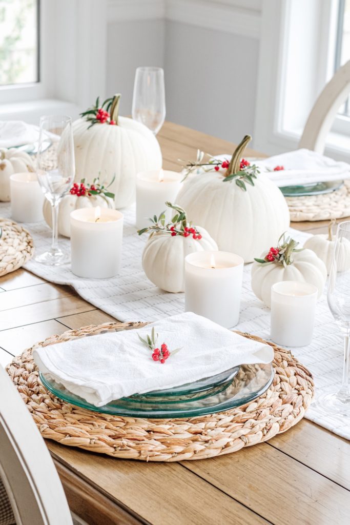 Neutral fall table setting with white pumpkins and red berries