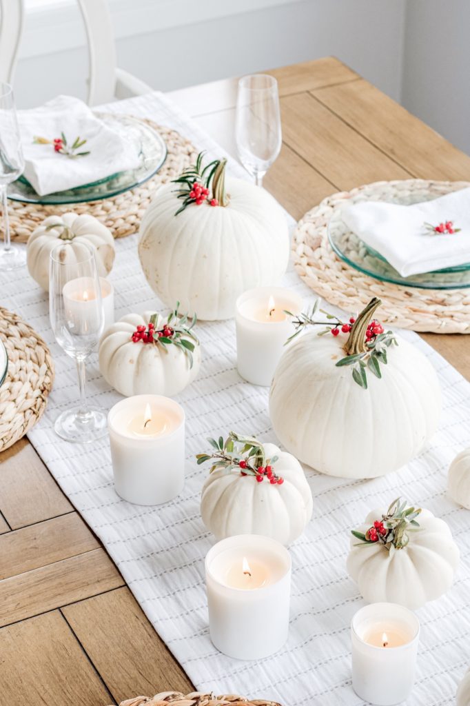 Overhead shot of white pumpkin and holly buffaloberry tablescape