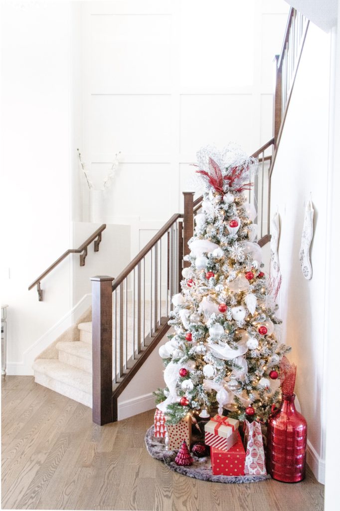 Far away look at white and red Christmas tree in entryway