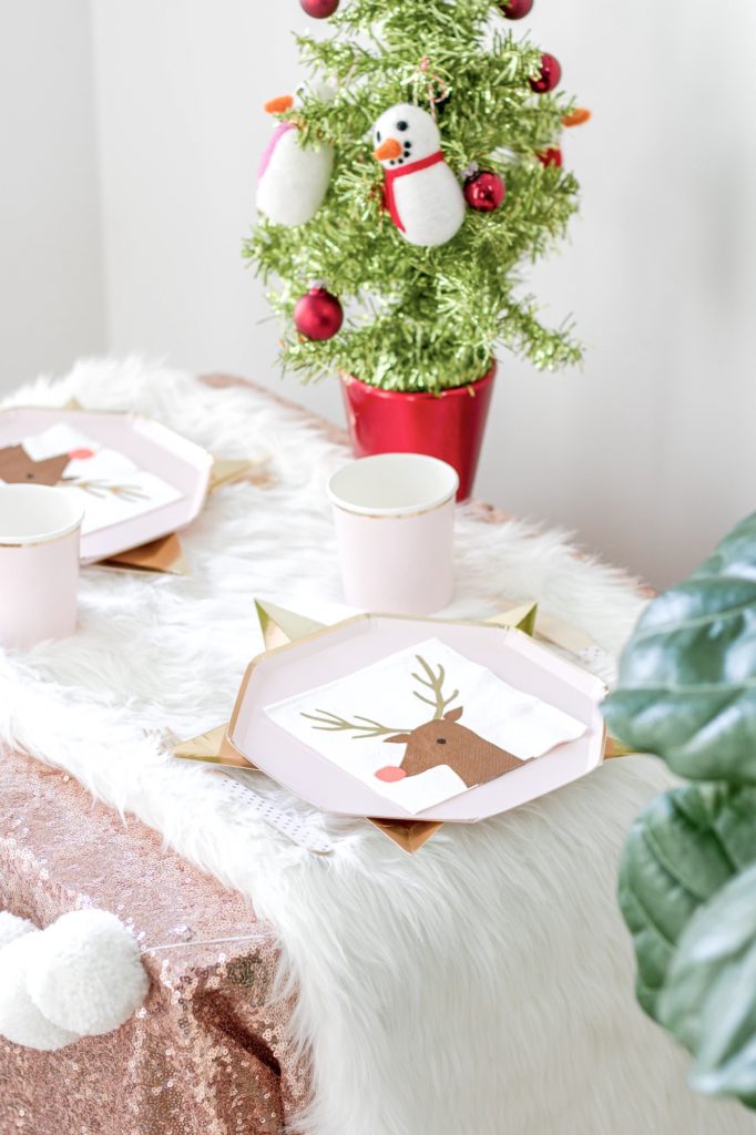 Closeup shot of blush pink kids Christmas table setting: fun and easy kids Christmas party ideas