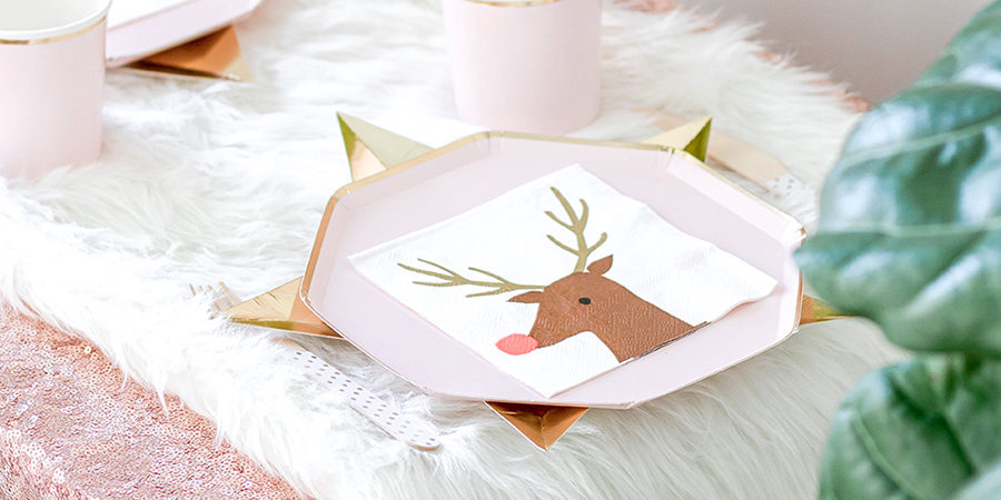 Pink paper plate and reindeer napkin: Kids’ Christmas Party Table