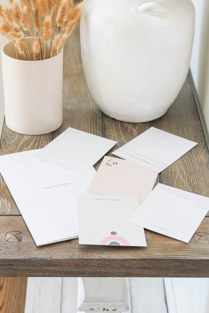 Basic Invite personalized stationery in blush pink colours on wood table