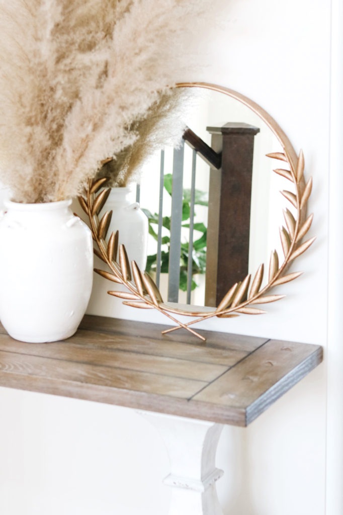 Gold wreath mirror with beige pampas grass
