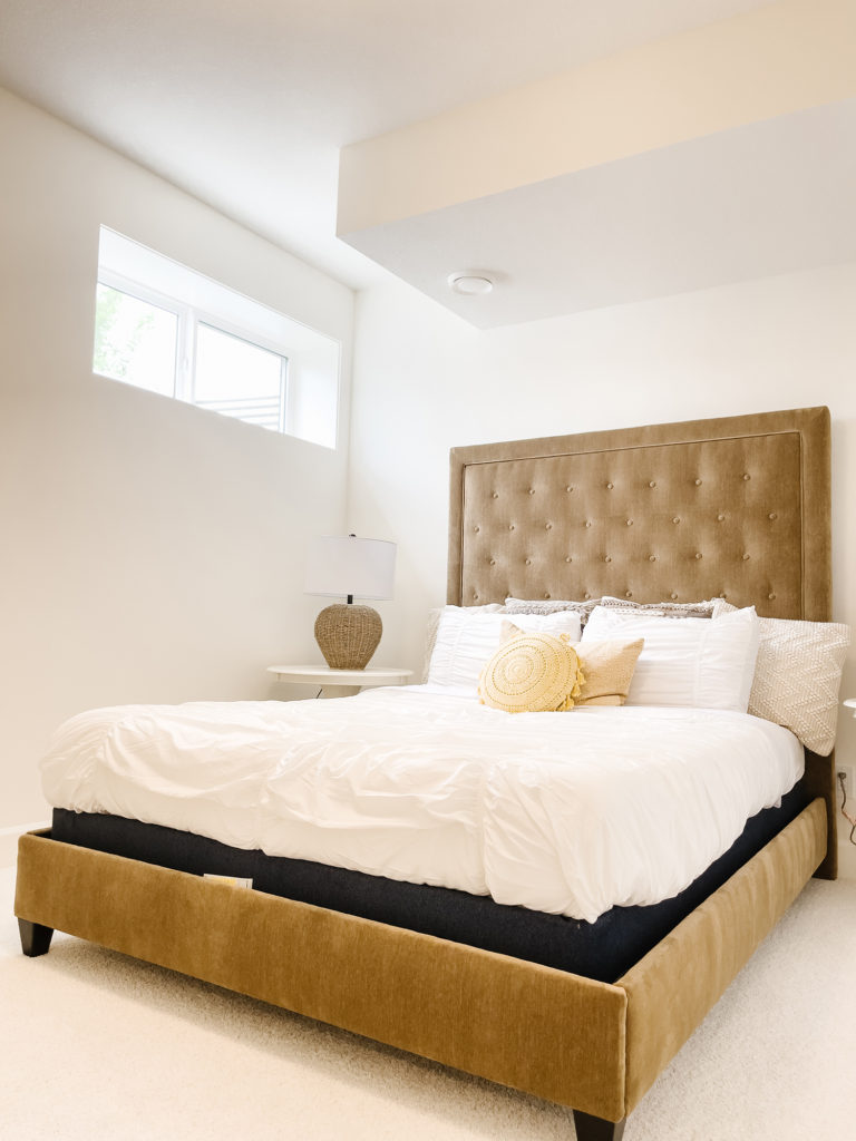 Basement Bedroom with tufted bed