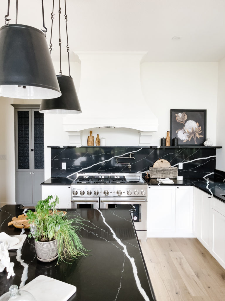 Kitchen with white cabinets and black countertops - kitchen inspiration
