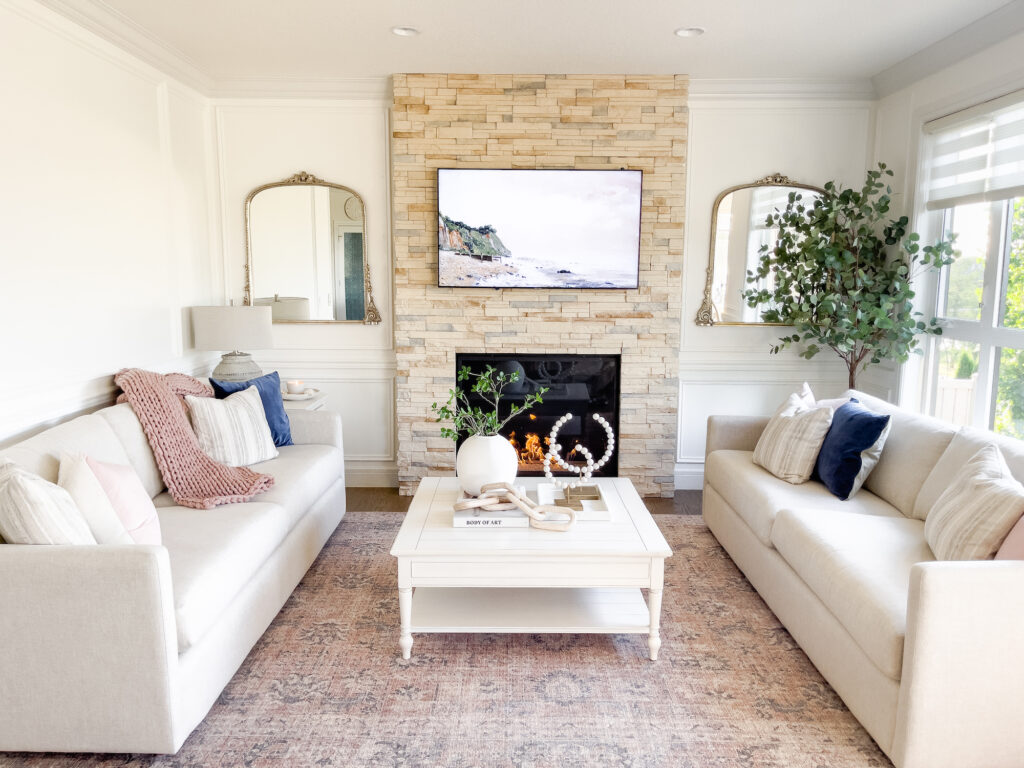 Neutral living room design with oversized fireplace and wall panelling